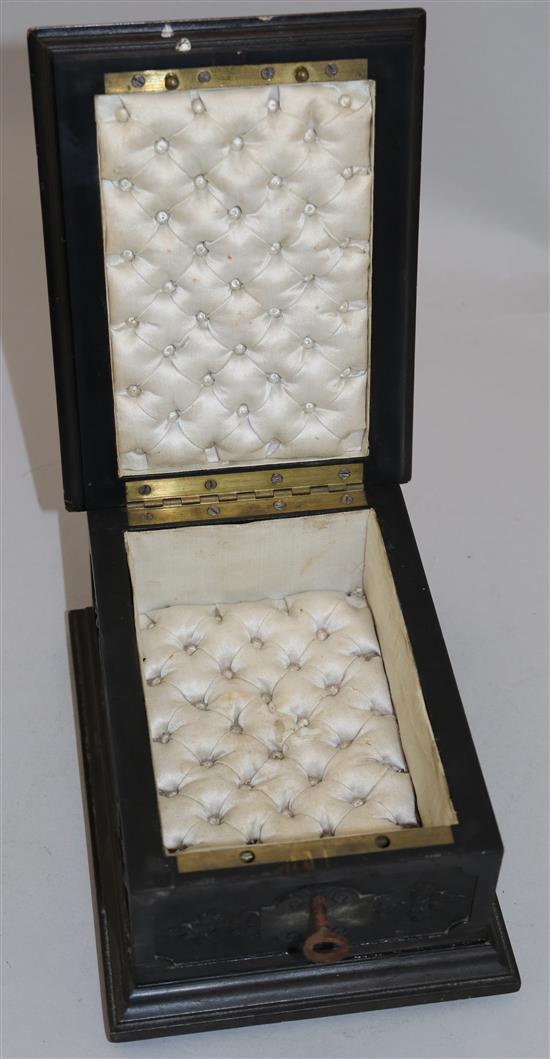 An early 19th century Limoges style enamel plaque set in a later carved ebonised casket, 7in.